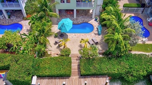 A resort with multiple swimming pools, a wooden dock, and lush greenery. - P88 -  New on the rental market! 3 bedroom, 2 bath with private pool and 50 feet of dockage (Marathon)