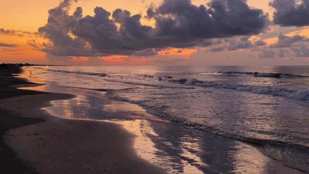 A beach with waves and a sunset. - This 3 bedroom beach house is the PERFECT space to get “A Wave From It All! "  (Crystal Beach)