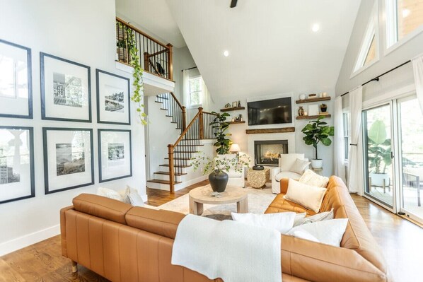 Smart-tv, een open haard, boeken en een kantoor