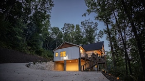 A two-story house with a wooden deck and a staircase leading to the upper level. - Cozy Luxury Treehouse, 10 Min To Asheville, Mountain Views (Swannanoa)