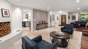 A spacious living area with a fireplace, a dining area, and a kitchen.