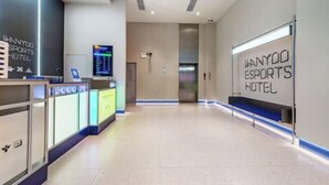 A modern hotel lobby with a reception desk, digital display, and a large wall sign. - Shengjia Theme Hotel (Guangzhou Dashi Metro Station) (Guangzhou)