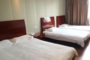 A hotel room with two single beds, wooden headboards, a nightstand, and a window with curtains. - Pinghu Yinjiang Hotel (Pinghu)