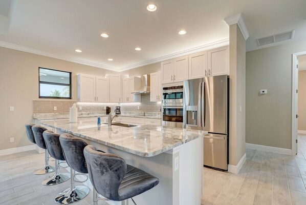 Fridge, microwave, oven, stovetop - Brand New 5 Bedroom Heated Pool Home with 6 Beds (Cape Coral)