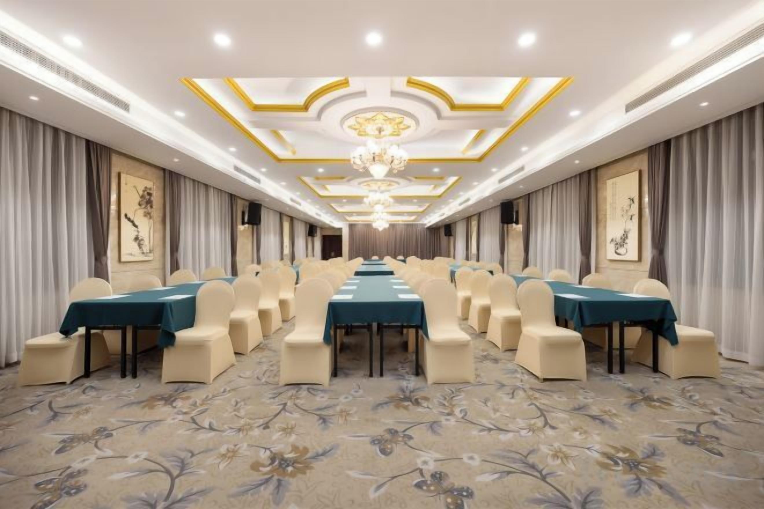 A conference room with a long table, chairs, and a chandelier.