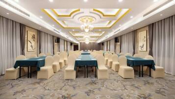 A conference room with a long table, chairs, and a chandelier.