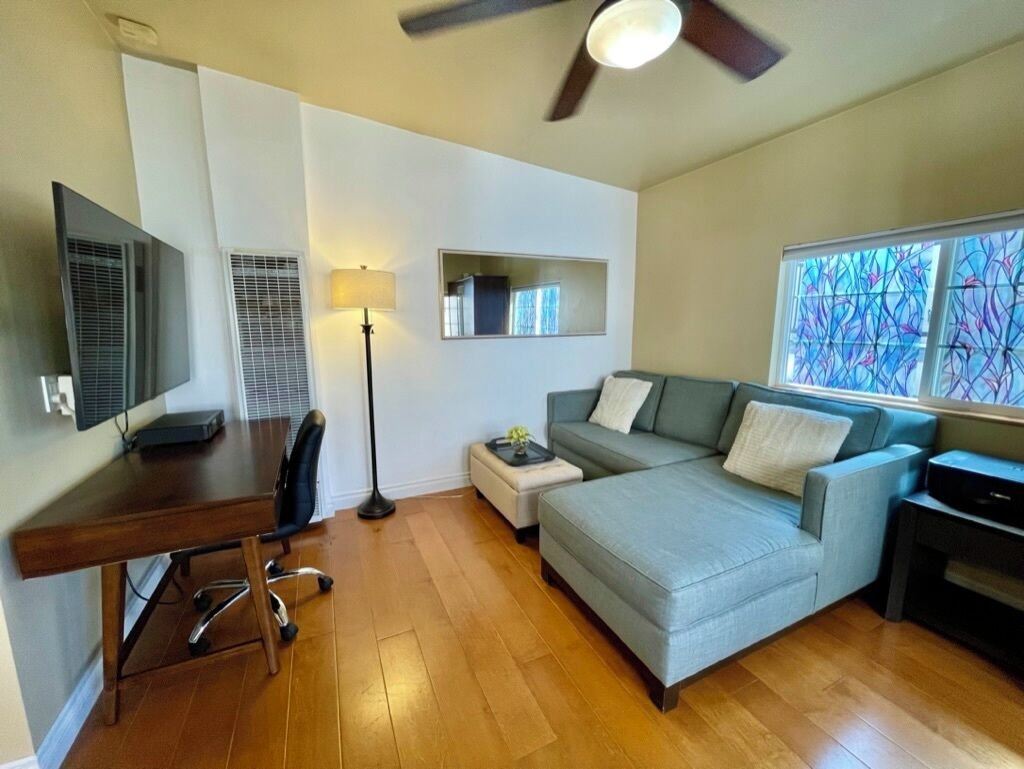 212 Living Room includes comfortable fabric sectional couch, ceiling fan, gas powered heater, laptop workstation, wall mounted 55" smart TV with 100+ YouTube TV stations.