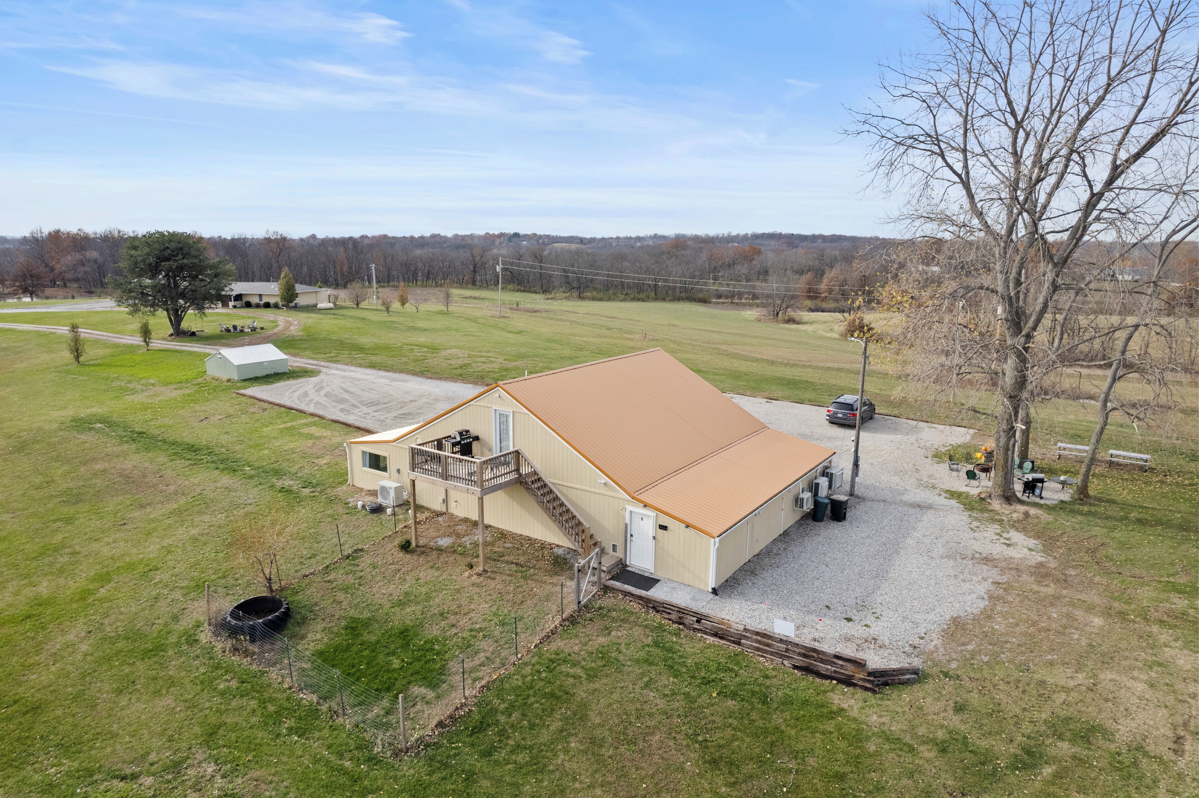 A single-story building with a flat roof, a covered porch, and a small attached garage.