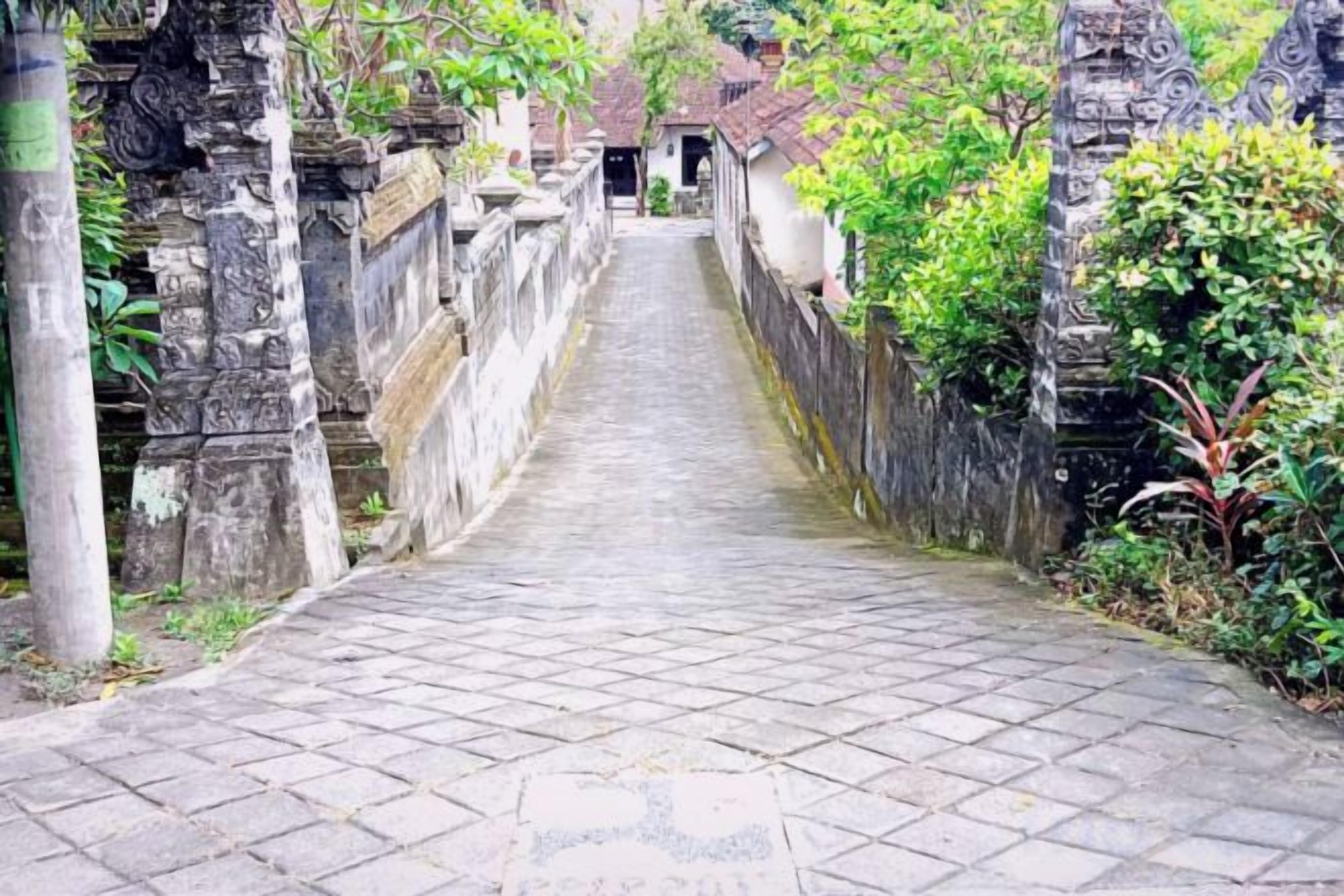 A stone pathway leading to a building with traditional architecture.