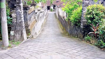 A stone pathway leading to a building with traditional architecture.