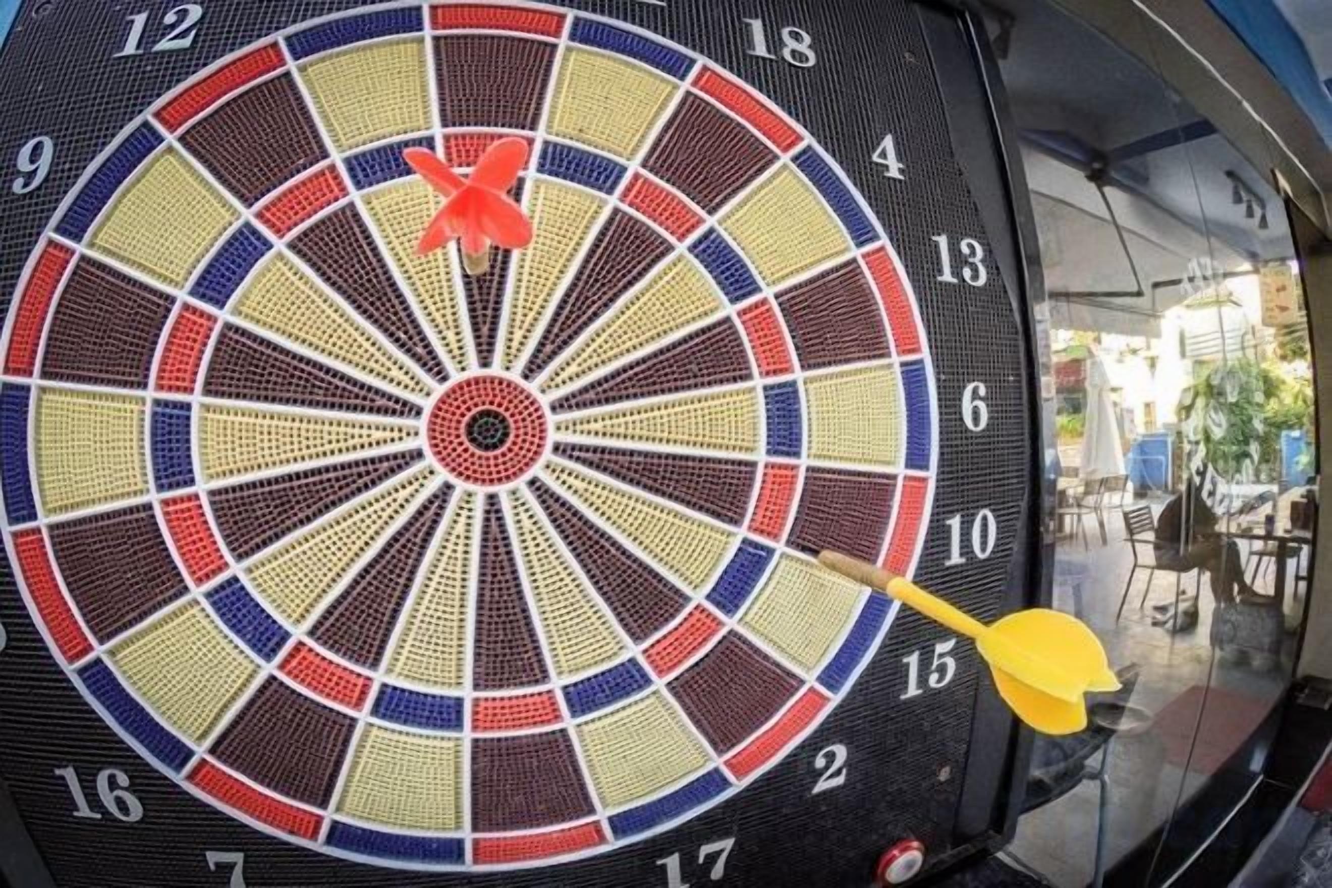 A dartboard with a dart stuck in the center, indicating a bullseye hit.