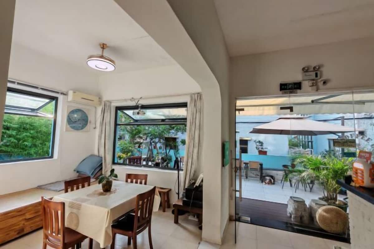 A dining area with a table, chairs, and a view of the outdoor patio.