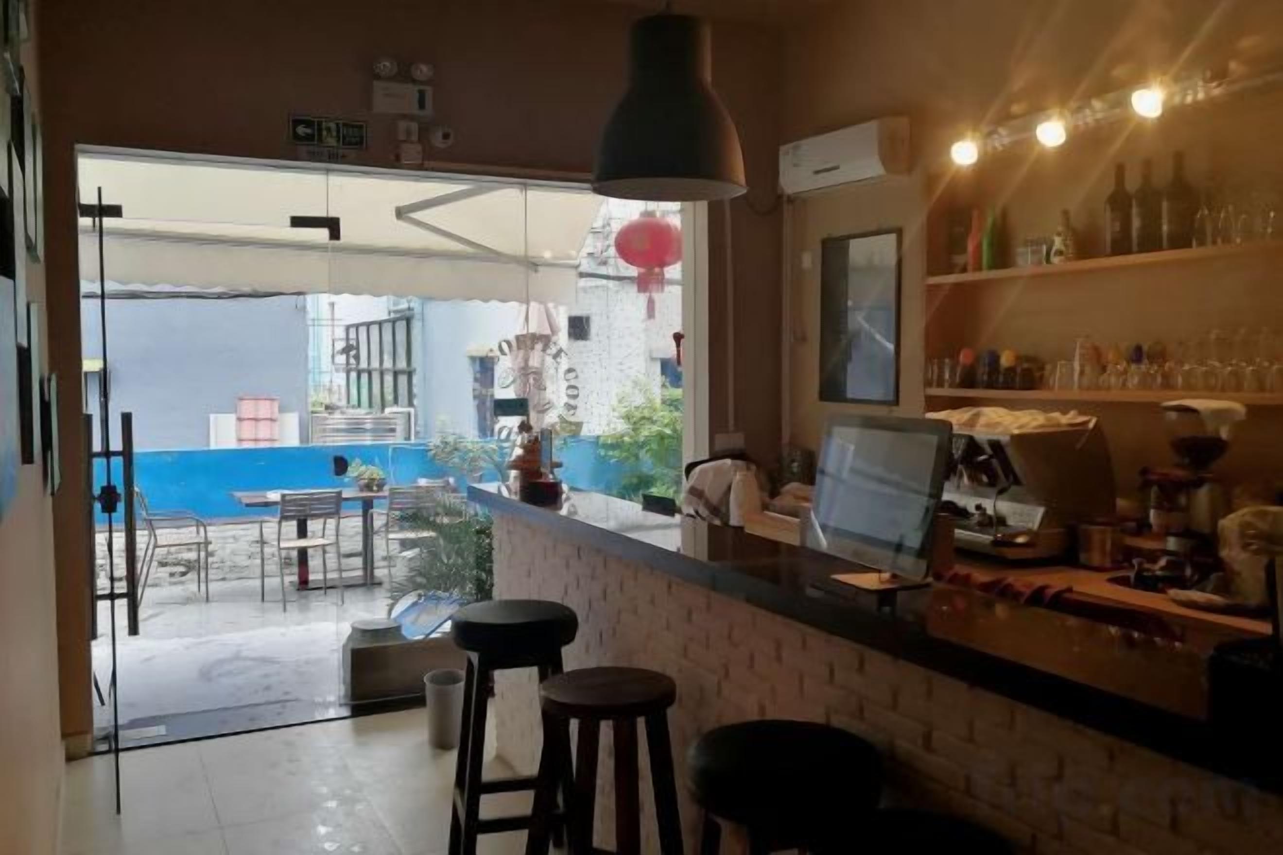 A bar area with stools, a counter, and a view of the outside.