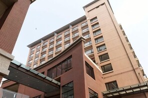 A multi-story building with a brick facade and large windows. - Academy Hotel (Tainan)
