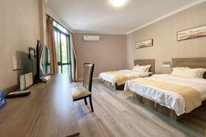 A hotel room with two beds, a desk, a chair, a TV, and a window with curtains. - Jindu Hotel Danghu Street (Pinghu)