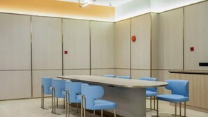 A conference room with a long table, six blue chairs, and a podium. - HanTing Hotel (Jiande Xin'an River Xindian) (Jiande)