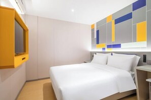 A modern hotel room with a large bed, a built-in TV, and a colorful abstract wall design. - 7Days Inn Hotel (Nanjing Lukou Airport) (Nanjing)