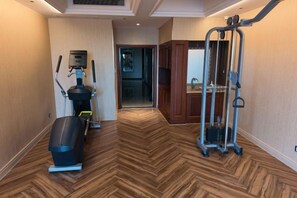A hallway with a herringbone floor pattern, leading to a door. - Gangxing Hotel (Zhuji)