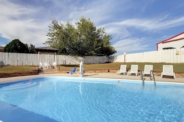Soak up the sun beside a sparkling pool and loungers.