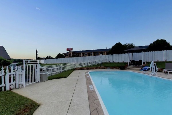 Dive into a refreshing swim on a sunny, open pool deck.