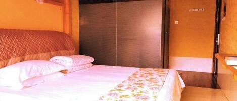 A bedroom with a bed, a window, and a door.