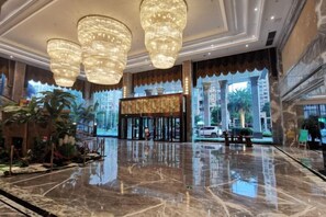 A spacious lobby with a polished marble floor, large chandeliers, and a grand entrance. - CHOUERY International Hotel (Wenzhou)