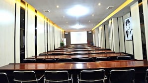A conference room with long tables and chairs, a projector screen, and a large window. - Yue Yue Scenic View Hotel(Zhengzhou Boudou·Xinxiang Confucius Temple Metro Station Store) (Zhengzhou)