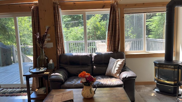A cozy living room with a leather sofa, a wooden coffee table, and a fireplace.