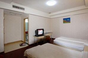 A hotel room with two beds, a desk with a computer, a mirror, and a painting on the wall. - Century Express Hotel (Tongxiang)