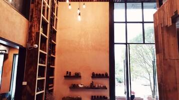 A room with wooden shelving, a ladder, and a large window.