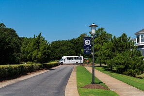 A road with a white van labeled "The Curnuck Club" parked on the side.