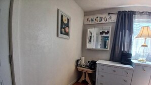 A room with a white dresser, a small table with a coffee maker, a trash can, a framed picture on the wall, and a window with curtains. - Private Room with Ensuite Bath - Separate Entrance and Exit! (San Jose)