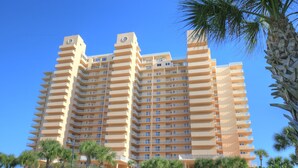 A high-rise hotel with multiple balconies and a central clock tower. - Peaceful Paradise by the Sea | Inlet #1103 (New Smyrna Beach)