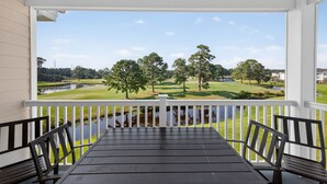A covered porch with a view of a golf course and a body of water. - MN 4811-304 | Stay in Golf Paradise Book for Golf Season (Myrtle Beach)