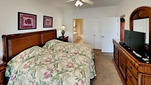 A bedroom with a bed, dresser, TV, and two framed pictures on the wall. - Myrtlewood Villa Close to Beach & Dining | Magnolia Pointe Luster Leaf 4837-201 (Myrtle Beach)