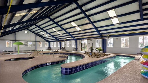 An indoor swimming pool with multiple lanes, a covered roof, and a seating area with chairs. - Pool View Bliss | Relax & Unwind | Myrtle Beach Awaits | Magnolia North 4827-202 (Myrtle Beach)