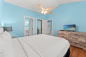 A bedroom with a bed, a ceiling fan, a dresser, and a television. - Serene Garden Views | Beach & Golf Retreat | Magnolia Place 4627-302 (Myrtle Beach)