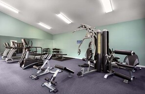 A gym with treadmills, weight machines, and a mirrored wall. - Magnolia Pointe Magnolia Lake 4833-204 (Myrtle Beach)