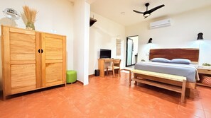 A bedroom with a bed, a desk with a computer, a wardrobe, and a ceiling fan. - Chic 3-bedroom villa with AC and WiFi in welcoming Puerto Escondido (Puerto Escondido)