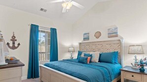 A bedroom with a bed, a nightstand, a dresser, and a ceiling fan. - Modern Magnolia Pointe Condo Near Myrtle Beach | Magnolia Pointe Luster Leaf 4861-403 (Myrtle Beach)