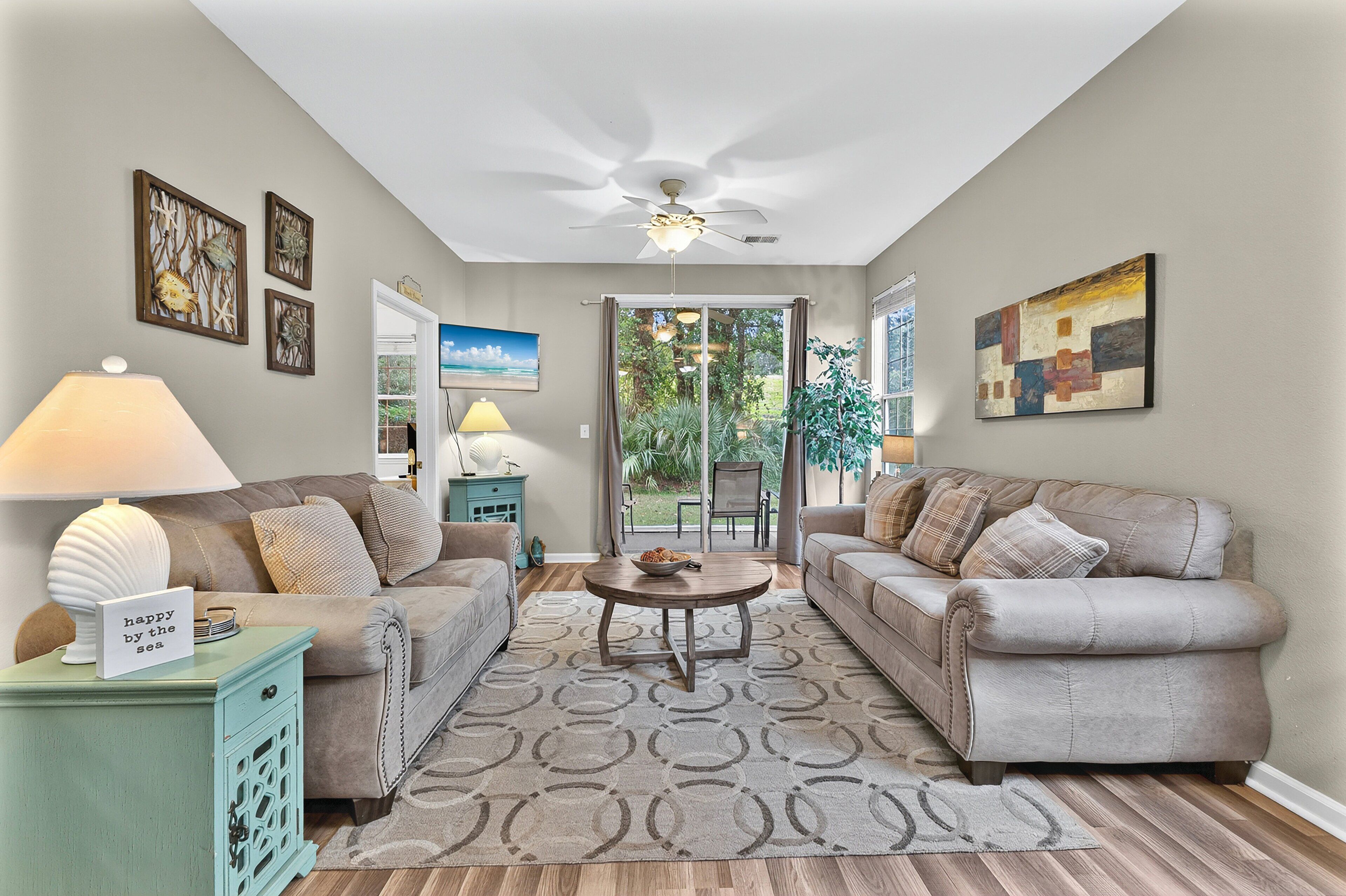 A living room with two sofas, a coffee table, a lamp, and a rug.