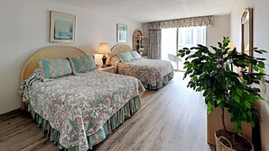 A hotel room with two beds, a large window, a plant, and a mirror. - Kingston Plantation South Hampton (Myrtle Beach)