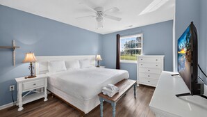 A bedroom with a bed, nightstands, a bench, a dresser, and a TV. - Myrtle Beach Fun | Golf & River Oaks Awaits You! | RO 5C (Myrtle Beach)
