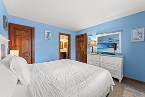 A bedroom with a bed, dresser, and a television. - Shipwatch Pointe II N104 (Myrtle Beach)