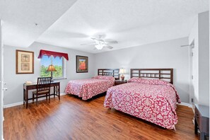 A bedroom with two beds, a desk, and a chair. - Yacht Club 2-505 - Three Bedroom (North Myrtle Beach)