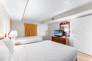 A hotel room with two beds, a television, a dresser, and a mirror. - Atlantica 154, Beachfront Myrtle Beach Sping Retreat (Myrtle Beach)