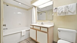 A bathroom with a bathtub, a sink, a toilet, a mirror, and a towel rack. - Atlantica 754, Beachfront Charm, Oceanfront Views, Beach Escape (Myrtle Beach)