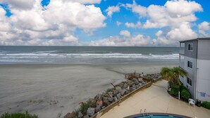 A beachfront property with a swimming pool, a wooden deck, and a view of the ocean. - Oceanfront 2BD- Cherry Grove Point- Ocean View K3 (North Myrtle Beach)