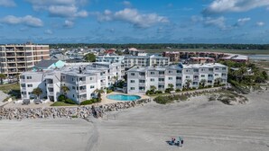 A beachfront hotel with multiple buildings, a swimming pool, and a sandy beach. - Oceanfront 2BD- Cherry Grove Point- Ocean View K3 (North Myrtle Beach)