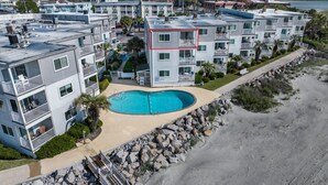 A multi-story residential building with a swimming pool, balconies, and a beach view. - Oceanfront 2BD- Cherry Grove Point- Ocean View K3 (North Myrtle Beach)